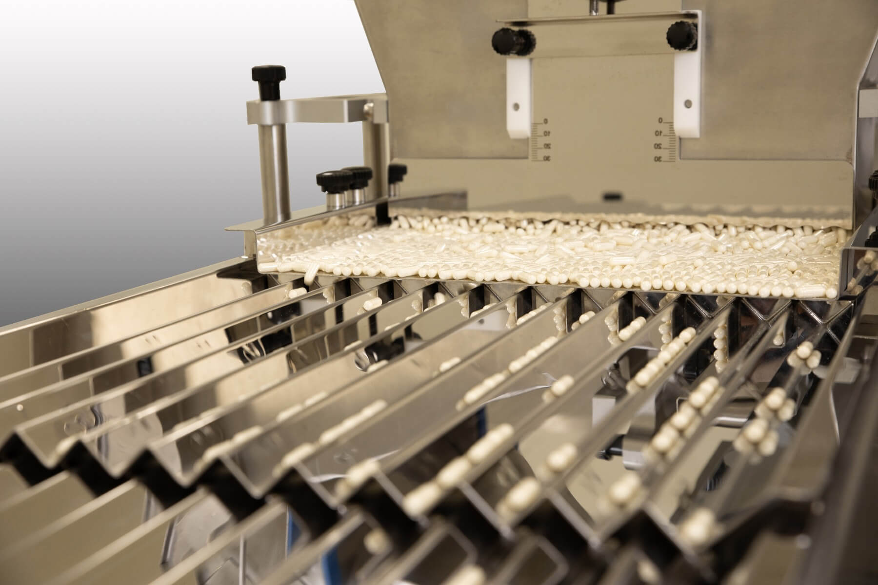 Tabletten in een trilgoot die worden afgevuld